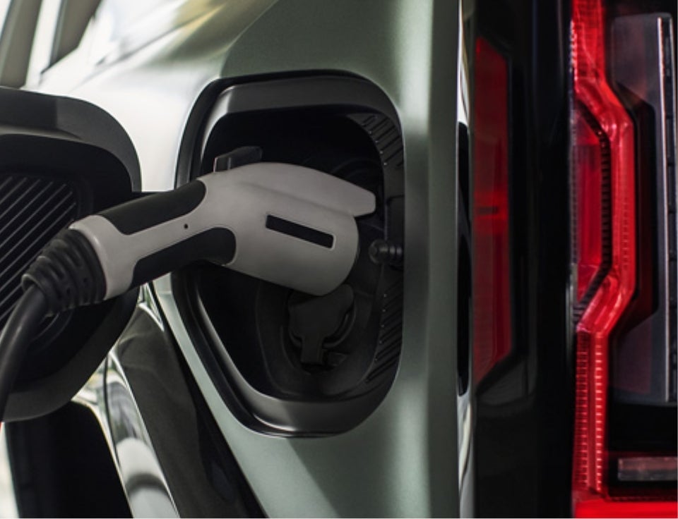 Close up of charging port with charger plugged in on a GMC Hummer EV SUV - Romeo Buick GMC in Lake Katrine NY